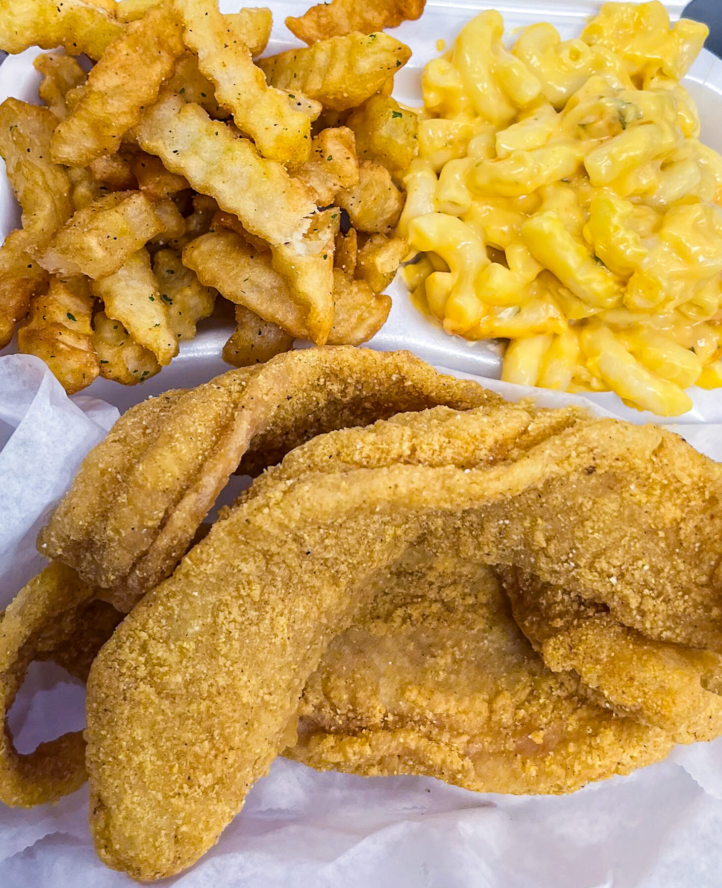 a to go dish of fried fish fillets, mac and cheese, and french fries from Mario's Westside Market in Las Vegas, NV